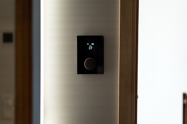 Modern smart home thermostat mounted on wall